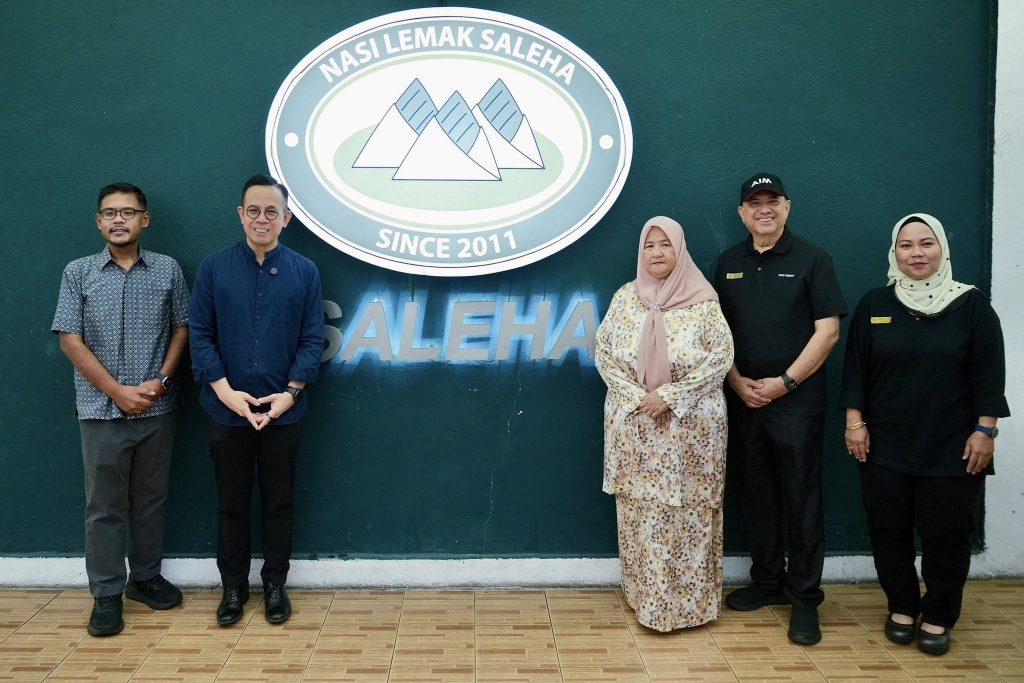 YB Steven Sim Chee Keong has highlighted the inspiring journey of local entrepreneur Saleha, whose humble nasi lemak business has grown from a roadside setup into a successful enterprise yesterday. Sharing the story, Steven Sim said Saleha began her business modestly, operating under an umbrella by the roadside, preparing and packaging nasi lemak on her own from home. Despite facing challenges, including occasional enforcement disruptions, her food quickly gained popularity among customers. Encouraged by strong demand, Saleha took a RM3,000 loan from Amanah Ikhtiar Malaysia (AIM) to expand her operations. That initial step marked the beginning of a steady growth trajectory. After 15 years of perseverance, her business—now widely known as Nasi Lemak Saleha—has transformed significantly. What started as selling around 100 packets a day has grown into a large-scale operation producing up to 15,000 packets daily. The business now includes a restaurant, a central kitchen, and employs dozens of workers. YB Steven Sim noted that Saleha’s success reflects the impact of continuous support from government-linked agencies, including SME Corp Malaysia and TEKUN Nasional. He added that Saleha was also recognised with the E50 Award by SME Corp, further cementing her status as a successful entrepreneur under initiatives linked to KUSKOP. He also highlighted the involvement of Saleha’s son, Dr. Rizal, a medical doctor who underwent training with the National Institute of Entrepreneurship (INSKEN) and now serves as Chief Operating Officer of the business. Today, Saleha is not only a successful entrepreneur but also a mentor figure—affectionately known as “Sis Long”—to other AIM entrepreneurs, inspiring many to pursue their own business ambitions. YB Steven Sim said her journey stands as a testament to resilience, determination, and the effectiveness of targeted support in uplifting small businesses into sustainable enterprises. -- MinutesMY / Igneseous Noris -- Photo: FB Steven Sim