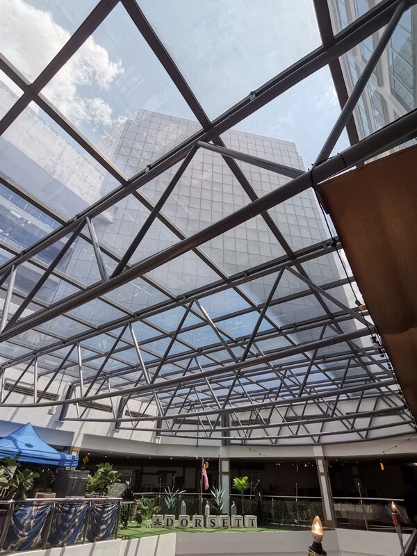 PUTRAJAYA, Malaysia, May 21, 2026 /PRNewswire/ -- i2Cool has completed the installation of its i2Film Electricity-free Cooling Film at Dorsett Putrajaya, helping the hotel address solar heat gain and improve guest comfort in its glass-fronted lake-view dining area. Located in Putrajaya, Malaysia, where the annual average temperature is around 28°C and hot, humid weather persists throughout the year, hotels built beside scenic waterfronts often face a dual challenge: maintaining open views while managing the heat load brought by strong sunlight. At Dorsett Putrajaya, Citra Rasa all-day dining restaurant is one of the hotel's signature spaces. Overlooking Putrajaya Lake, the restaurant is known for its lake-view dining experience and local Malaysian flavours, including Nasi Lemak and Nasi Goreng. However, the large floor-to-ceiling glass façade also created a long-standing comfort issue, especially for tables close to the windows. According to feedback from hotel staff, window-side tables were often left empty during busy weekend brunch hours, as guests would ask whether those seats were too hot. The issue was not simply a matter of air-conditioning capacity. Under prolonged sunlight, the glass itself became a continuous heat source, transferring heat into the indoor space. The hotel's engineering team had been aware of the issue for nearly two years. The key technical question was whether the heat-insulating film should be installed on the interior or exterior side of the glass. While interior application is shielded from weather, site evaluations revealed significant drawbacks, including structural instability of the existing trusses for worker access and the high risk of disrupting operations within the restaurant. After rounds of technical discussion and on-site comparison testing, i2Cool provided the hotel with a detailed technical assessment showing that exterior installation offered stronger advantages in heat dissipation and thermal insulation for this project. By installing the film on the exterior side, solar radiation could be reflected before acting on the glass, helping block heat at the source and maintain a lower glass substrate temperature. The hotel ultimately selected i2Film Electricity-free Cooling Film EFC-Blue 70e and adopted exterior-side installation. The project covered a total area of 421.6 square metres and was completed on 9 March 2026, ahead of Malaysia's hottest period of the year. Following installation, on-site monitoring showed a significant improvement in thermal and lighting performance: Solar irradiance decreased from 230.9 W/m² to 73.5 W/m², representing a 68.16% reduction. Illuminance was adjusted from 5,714 Lux to 4,830 Lux, reducing excessive heat while maintaining a bright indoor dining environment. With up to 94% mid-infrared emissivity, i2Film helps release heat absorbed by the glass surface without additional electricity consumption. The 421.6 m² installation is estimated to help the hotel save approximately 137,915.3 kWh of air-conditioning energy per year. Beyond the data, the change was also reflected in guest experience. According to follow-up feedback, guests who previously felt a burning sensation when seated near the windows now described the space as bright but no longer uncomfortably hot. Another business guest also noted that it was the first time he had finished a meal there without feeling sweaty on his back. According to the hotel's front office manager, staff no longer need to explain that the window-side tables may feel hot. During weekend brunch hours, some guests now actively ask to be seated by the windows. For a hotel that receives hundreds of diners every day, the shift from "avoided seats" to "preferred seats" is a clear validation of the improvement. For hotel operations, the project also delivers practical energy-saving value. The 421.6 m² installation is estimated to help save approximately 137,915.3 kWh of air-conditioning energy per year. However, according to an internal review by the hotel management, the most valuable outcome was not only the number on the electricity bill, but the fact that the hotel no longer needs to struggle with the same long-standing issue. The Dorsett Putrajaya project provides a practical reference for glass façade buildings in tropical regions seeking to improve thermal insulation and reduce cooling demand. From the technical discussion two years ago to the final decision to adopt exterior-side installation, the project shows how a practical material-level cooling solution can help balance scenic views, indoor comfort and energy efficiency. For i2Cool, the 421.6 m² application at Dorsett Putrajaya is one example among more than 500 projects across nearly 30 countries and regions. From Dubai Mall to lakeside restaurants in Putrajaya, from data centres to star-rated hotels, electricity-free cooling technology is turning "light transmission without excessive heat" from a technical concept into a tangible cooling experience. -- Source: i2Cool Limited