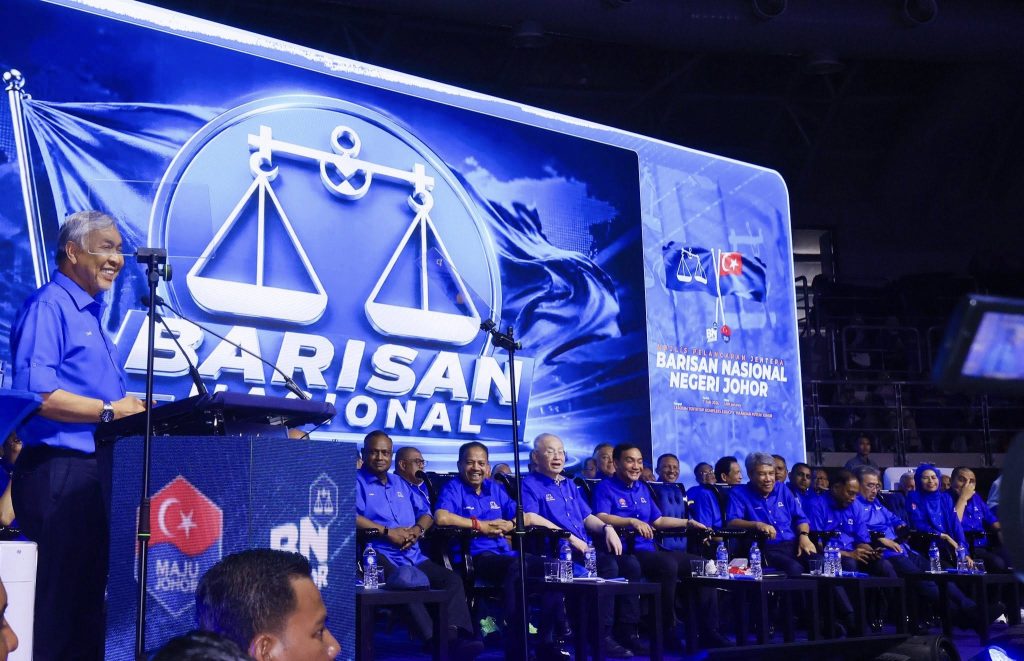 ISKANDAR PUTERI, June 8 — Thousands of Barisan Nasional (BN) supporters gathered at the Indoor Stadium of the Educity Complex in Iskandar Puteri on Sunday for the official launch of the Johor BN election machinery, signalling the coalition’s readiness for the upcoming Johor state election. The event was officiated by BN Chairman, Dato’ Seri Dr Ahmad Zahid Hamidi, and attended by Johor Menteri Besar Dato’ Onn Hafiz Ghazi, who also serves as Chairman of the Johor Barisan Nasional Coordination Committee. The stadium was filled with a sea of blue as party members and supporters from across the state turned up in large numbers to demonstrate their support for the coalition. During the event, BN leaders also witnessed the presentation of adopted states (“Negeri Angkat”) and the launch of the official Johor BN theme song in conjunction with preparations for the anticipated state election. In his address, Ahmad Zahid expressed confidence in Johor BN’s readiness to face the polls, highlighting the coalition’s governance record and development achievements in the state. Party leaders reiterated that Johor voters would be able to assess BN’s performance and leadership, particularly under the administration led by Onn Hafiz Ghazi. The event concluded on a high note, with enthusiastic supporters filling the stadium and creating a vibrant atmosphere as BN intensified its preparations for the state election campaign. The Johor state election is widely expected to be a key political contest, with parties beginning to mobilise their machinery and strengthen grassroots support across the state. -- MINUTESMY -- SOURCE: FB BARISAN NASIONAL