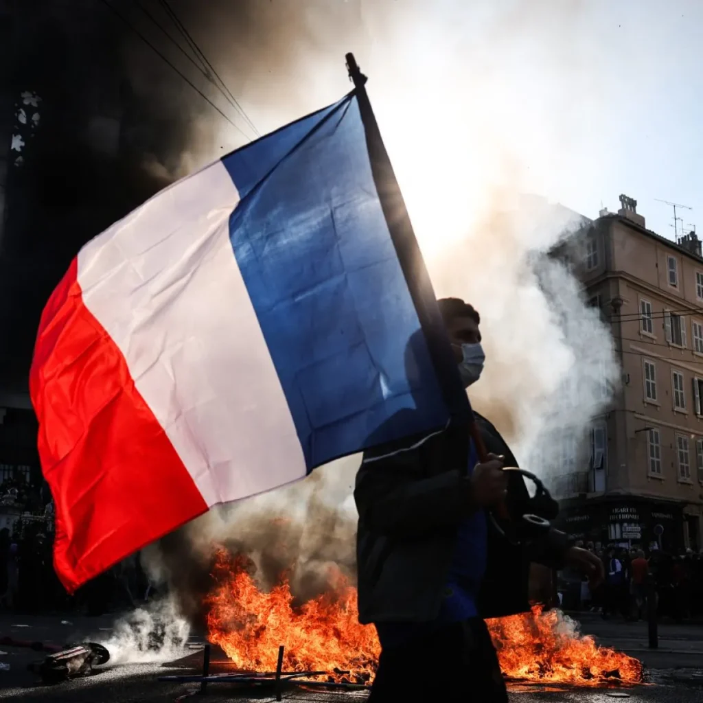 A protester holds a French flag during a demonstration in Lyon, France.