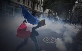 A protester holds a French flag during a demonstration in Lyon, France.